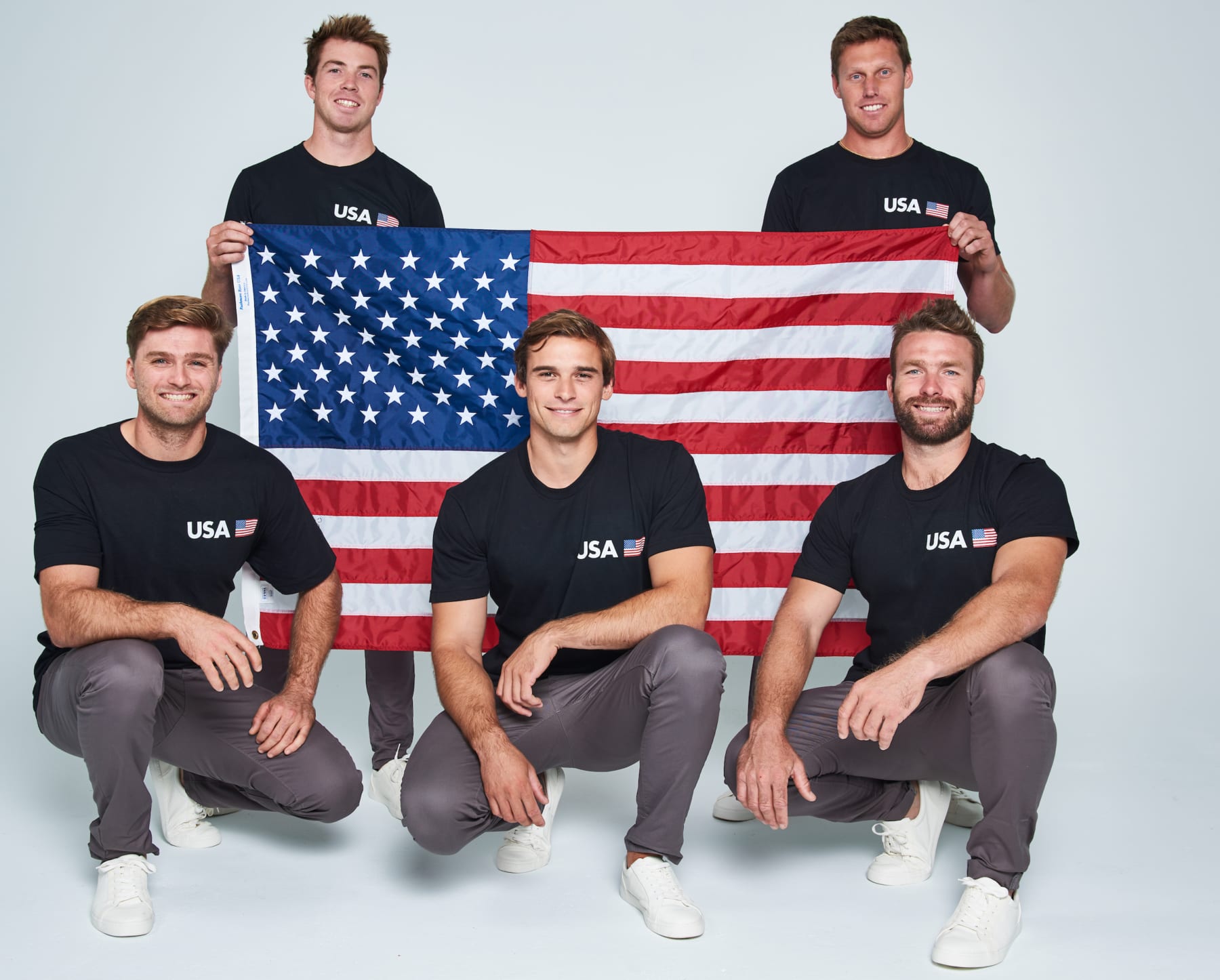 United States SailGP team pose for a team photo with their national flag. Standing left to right: Riley Gibbs USA and Rome Kirby USA. Kneeling left to right: Hans Henken USA, Mac Agnese USA and Dan Morris USA. 09 October 2018. Photo: Getty Images for SailGP
